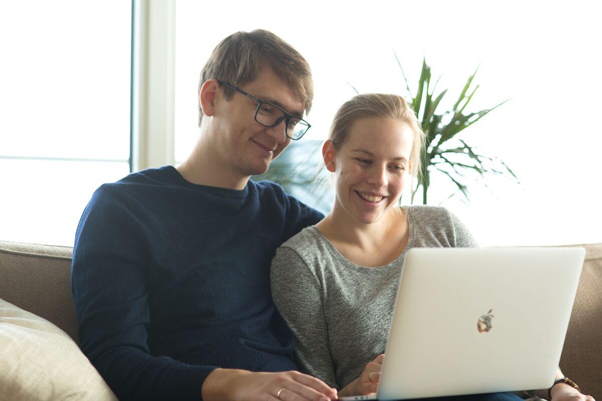 A couple, man and woman, looking at a computer together. Maternity healthcare solutions