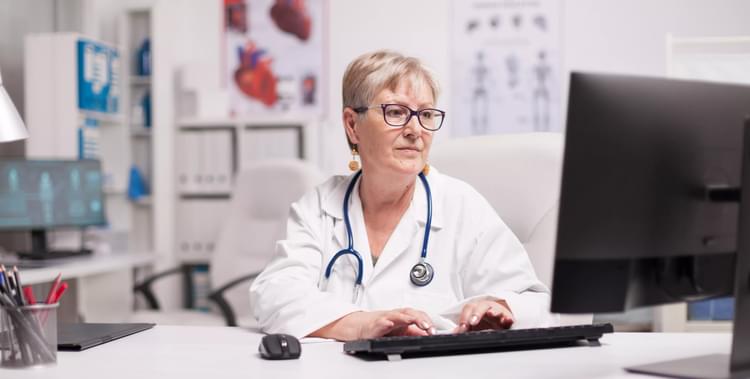 Lack of funding in healthcare - Shows a doctor at her desk