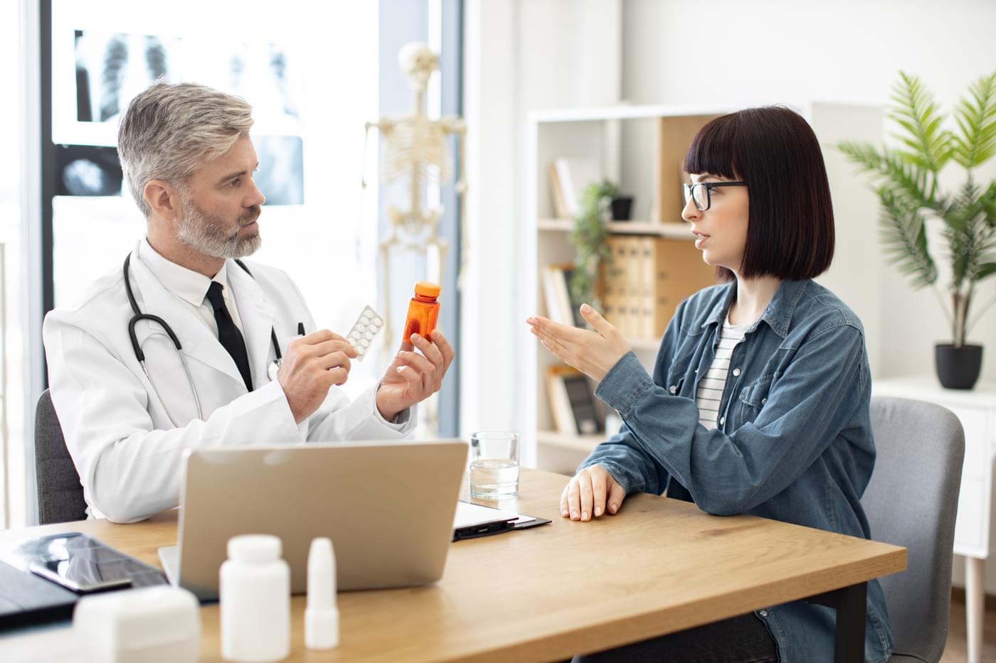therapist-holding-medications-near-woman-in-doctor-2023-05-31-16-51-34-utc-Omda-04 therapist holding medications near woman in doctor 2023 05 31 16 51 34 utc Omda 04