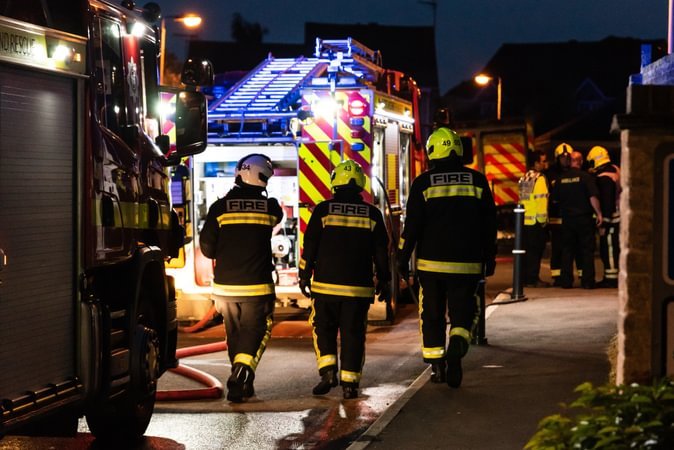 Emergency response preparedness and planning - Shows fire fighters walking by a fire engine